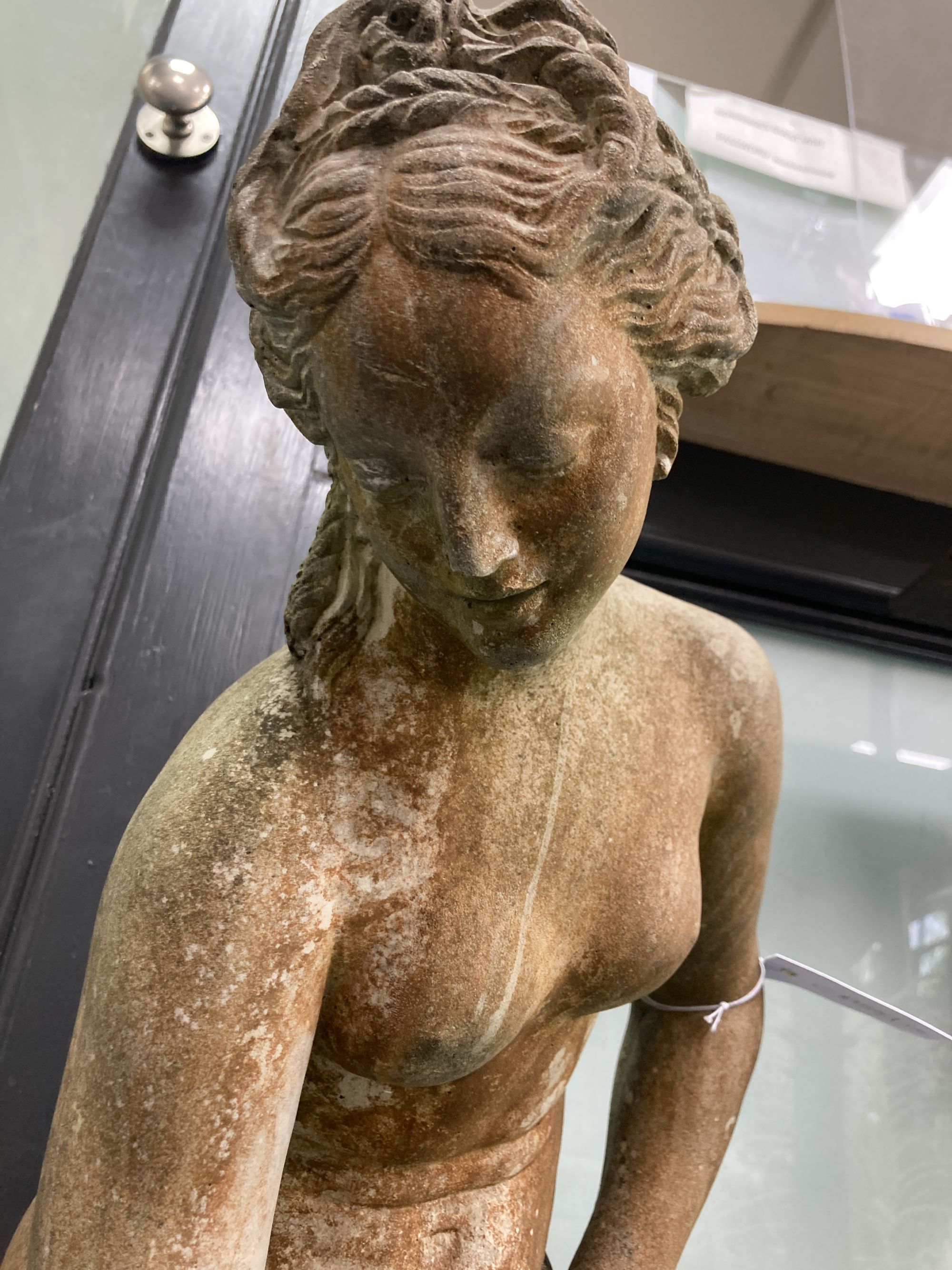 A reconstituted stone garden ornament of a female bather, height 74cm